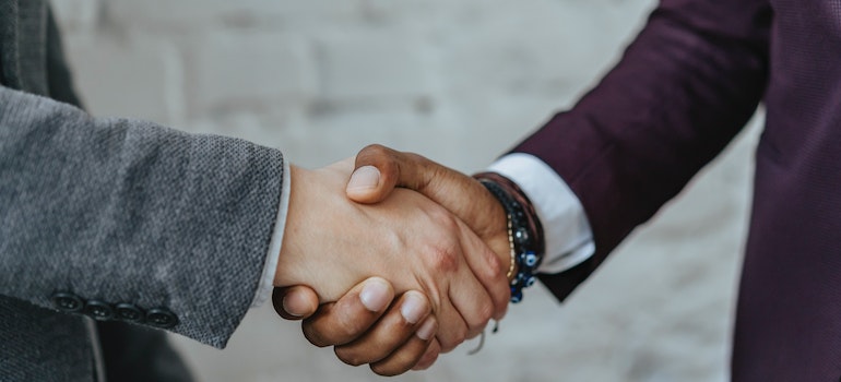 Two persons shaking hands